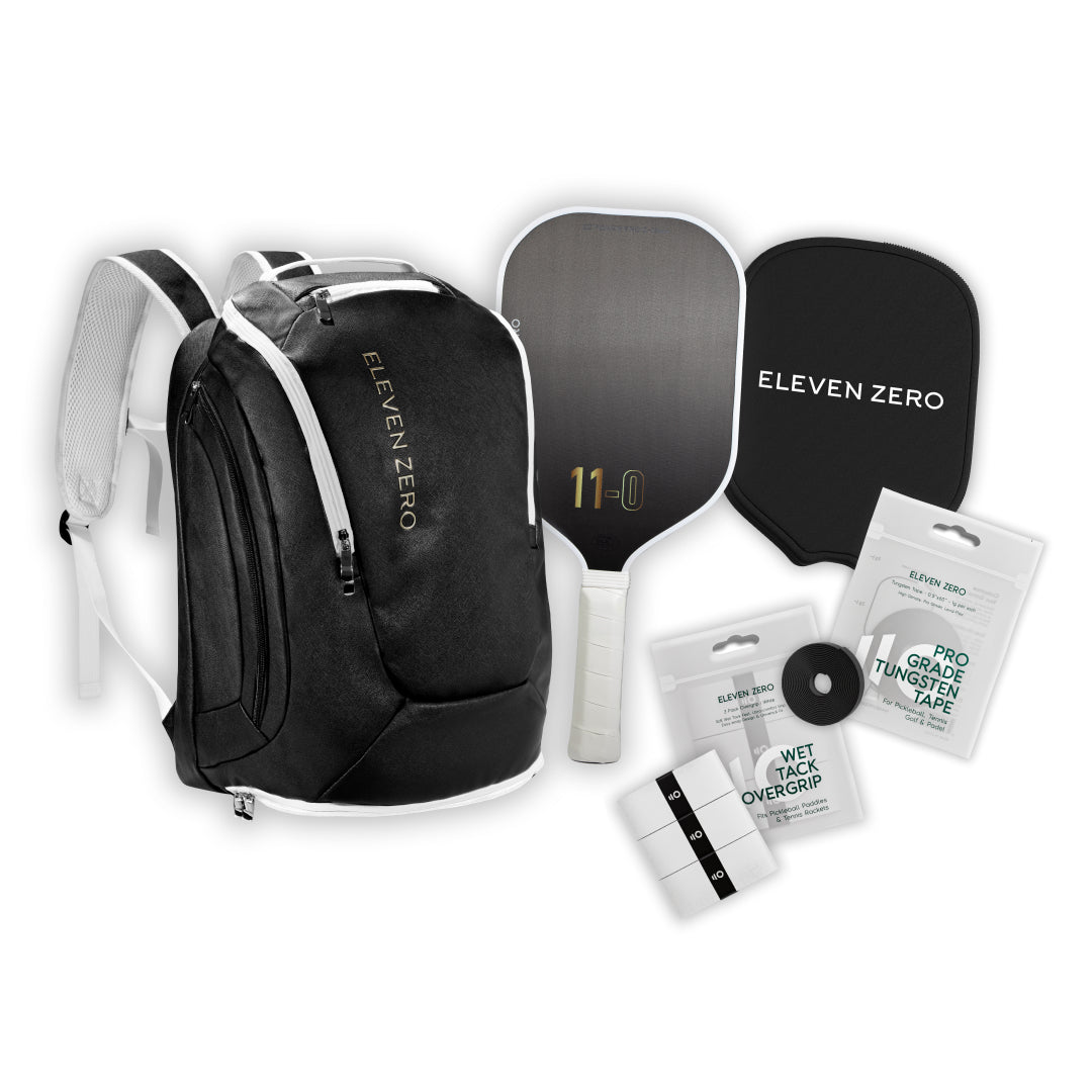 Full gear layout featuring a black Eleven Zero backpack, carbon paddle, paddle cover, overgrips, and tungsten tape.