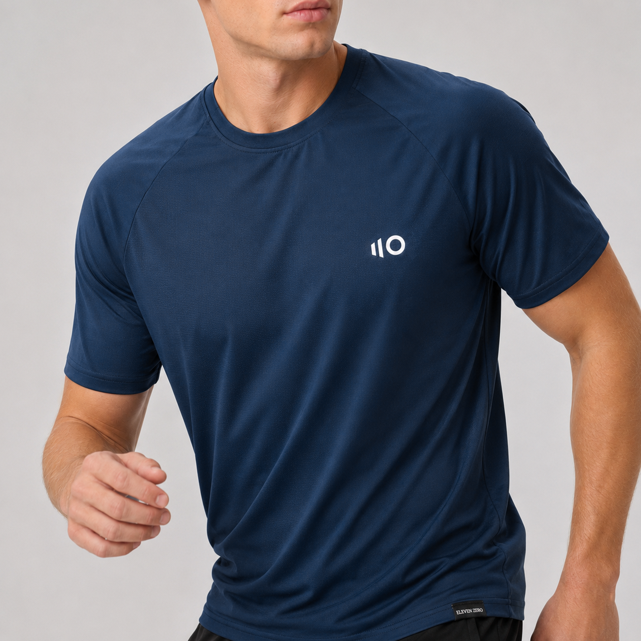 Man wearing a navy blue t-shirt on a light gray background