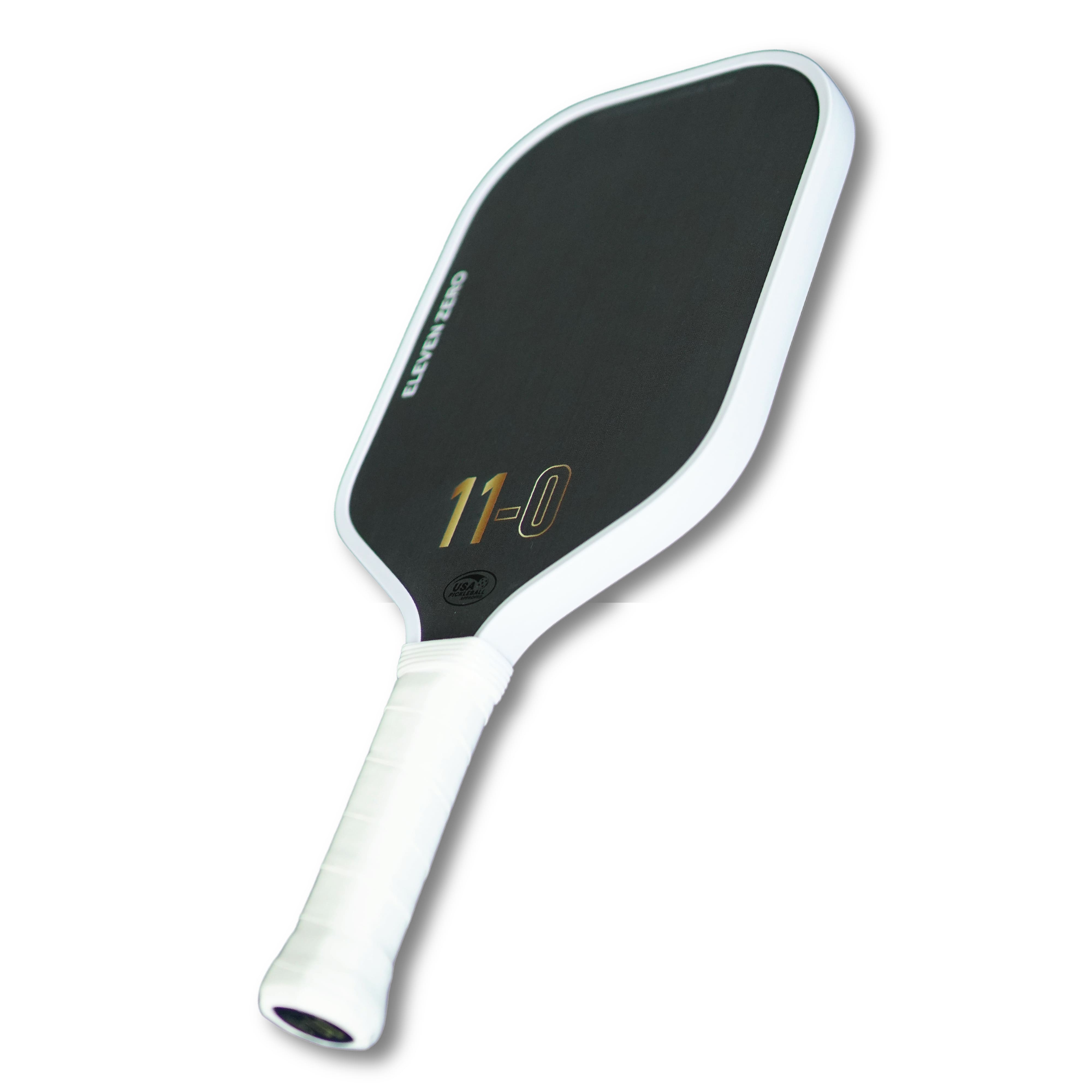Angled side view of the Eleven Zero Carbon paddle showcasing surface texture and handle wrap