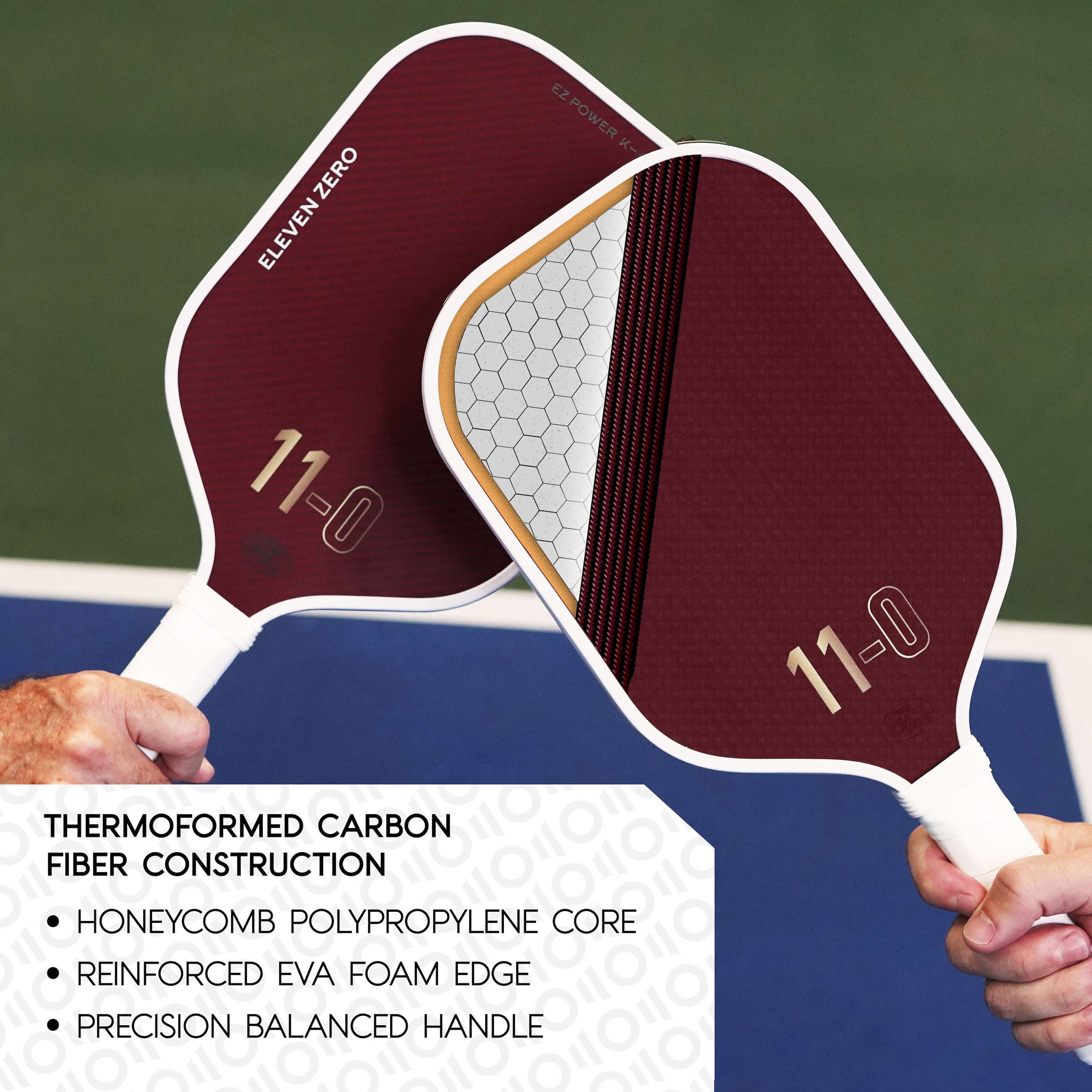 Two maroon Eleven Zero pickleball paddles highlighting their thermofored Aramid Carbon construction, featuring a honeycomb polypropylene core, reinforced EVA foam edge, and a precision-balanced handle for optimal performance.