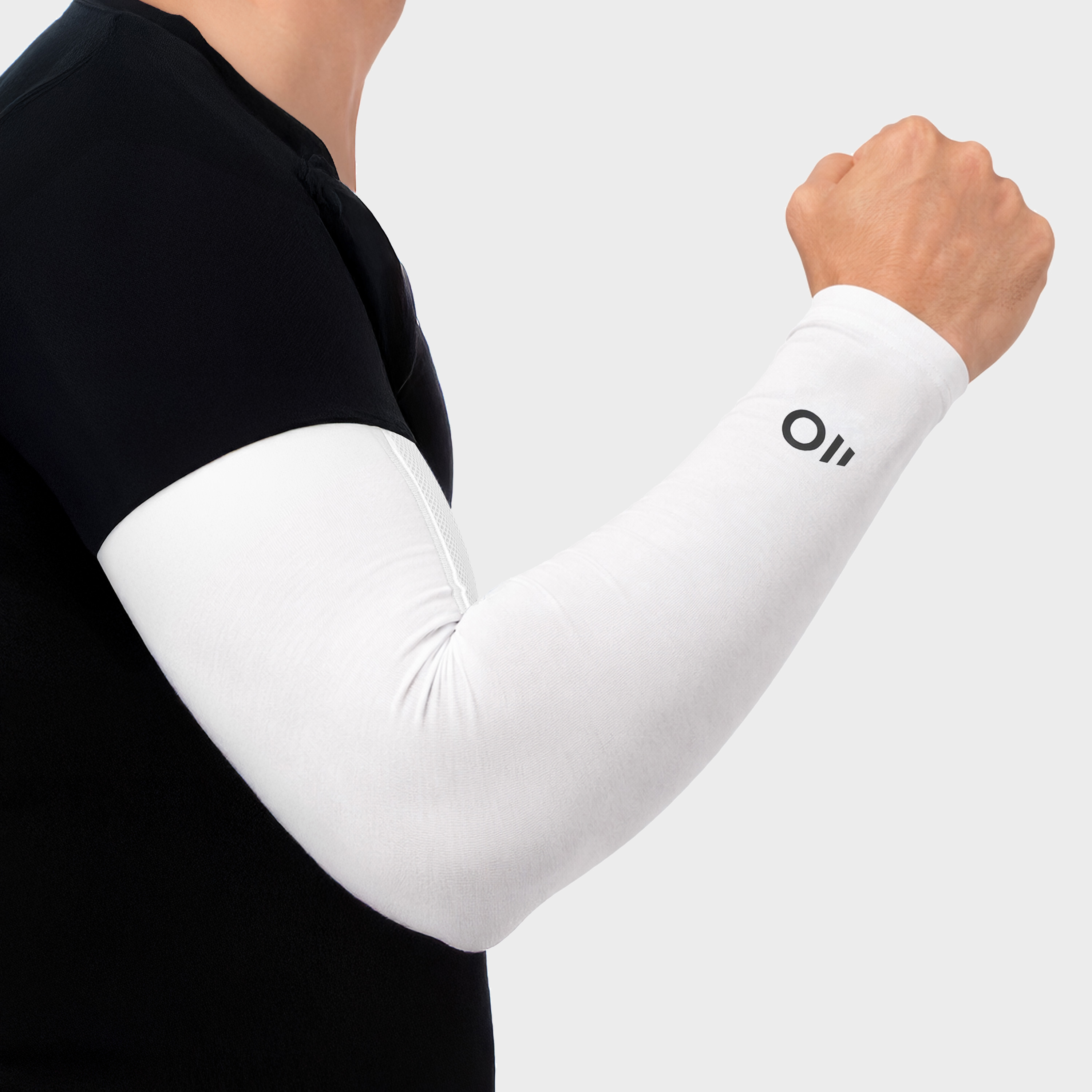 Man wearing black athletic shirt and white arm sleeves on a light gray background