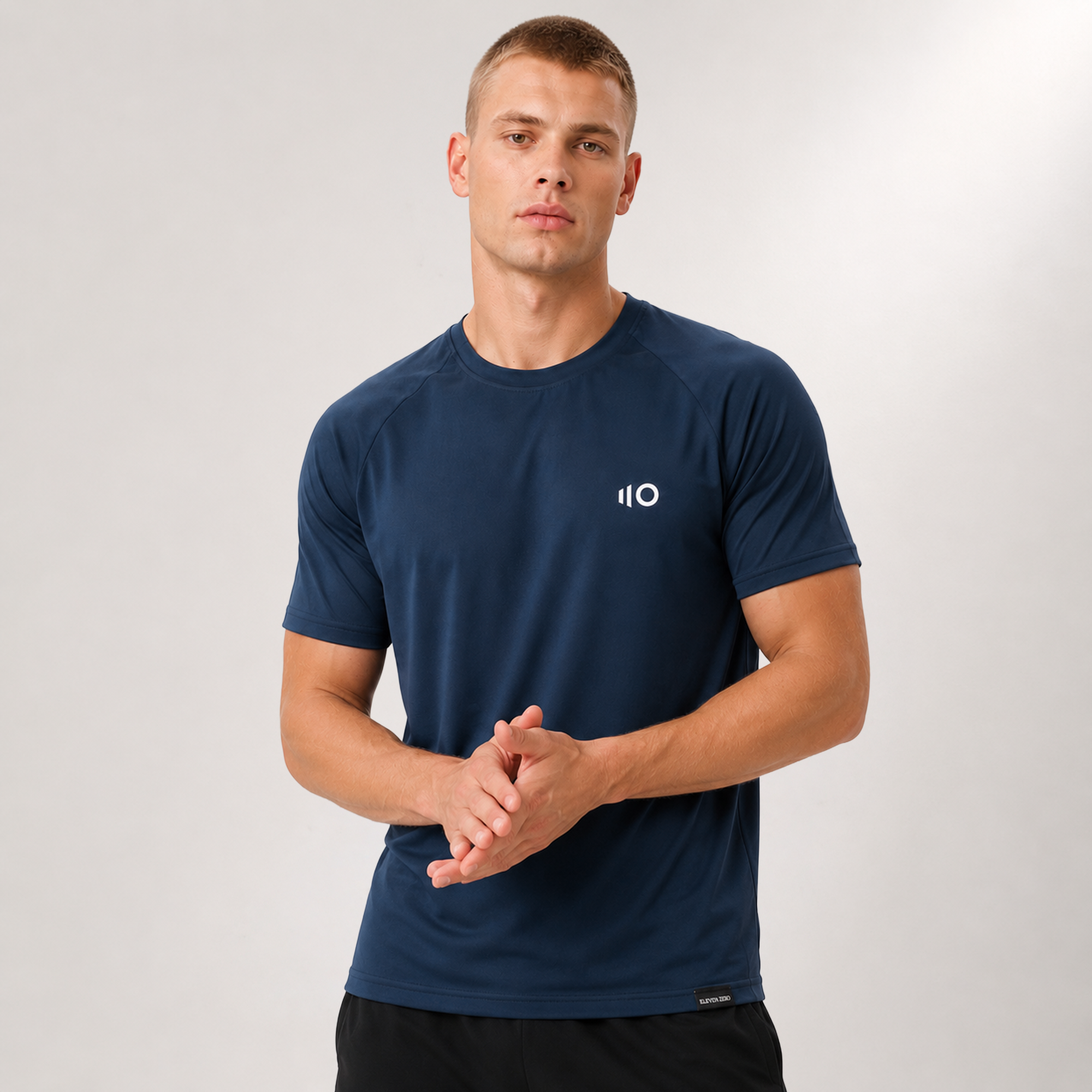 Man wearing a navy blue athletic shirt with Eleven Zero logo on a light gray background
