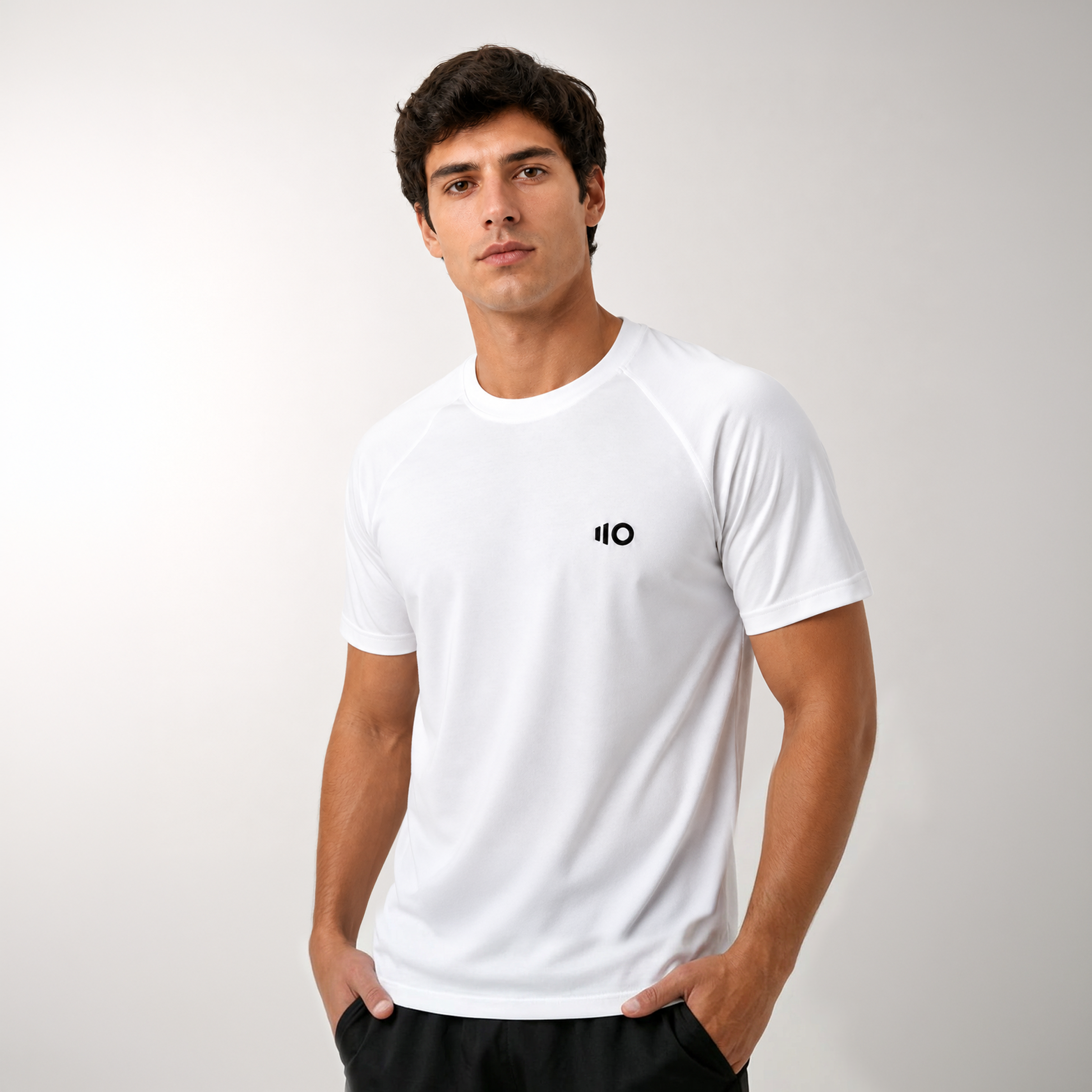 Man wearing the white unisex t-shirt with Eleven Zero logo on a plain background