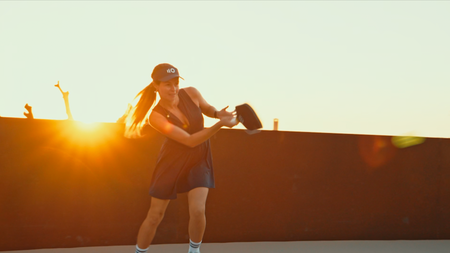 PPA pro Camila Zilveti playing pickleball with an Eleven Zero paddle in summer evening light