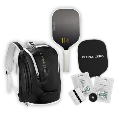 Black Eleven Zero pickleball backpack with carbon paddle, paddle cover, wet tack overgrip pack, and pro-grade tungsten tape.