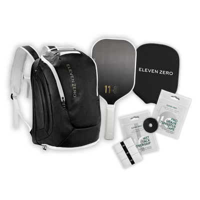 Full gear layout featuring a black Eleven Zero backpack, carbon paddle, paddle cover, overgrips, and tungsten tape.