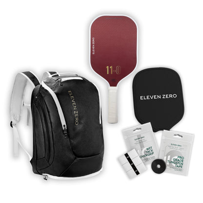 Black Eleven Zero backpack paired with a Kevlar pickleball paddle, paddle cover, overgrips, and tungsten tape.