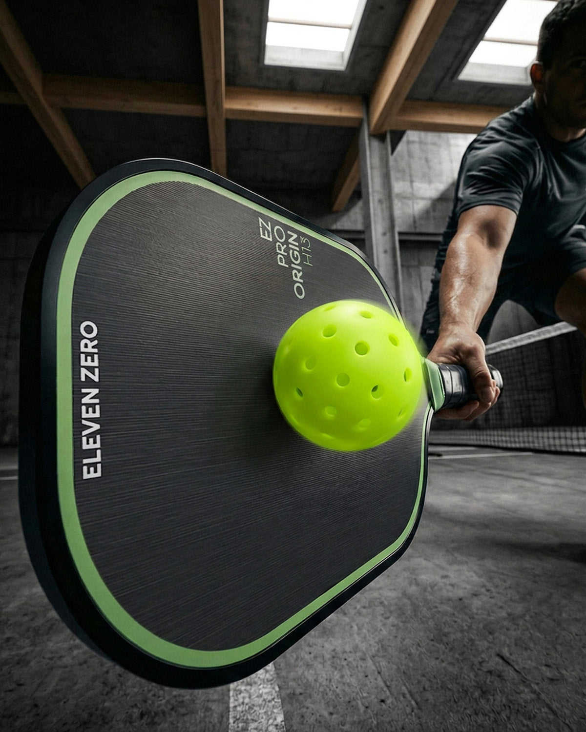 Athlete striking the ball with the EZ Paddle at the moment of impact.