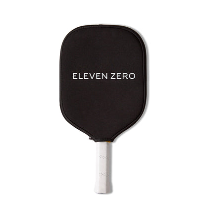 Black Eleven Zero pickleball paddle cover with white logo, shown flat with paddle handle extending below.