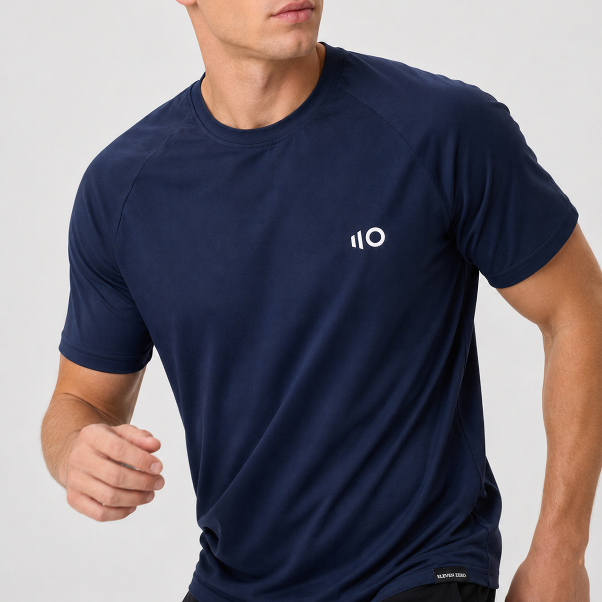 Man wearing a navy blue t-shirt on a light gray background