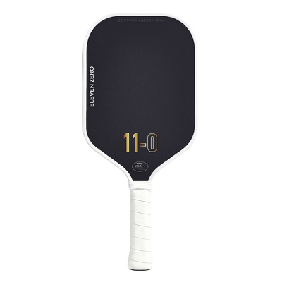 Front view of the Eleven Zero Carbon pickleball paddle in black with gold “11-0” logo and white trim