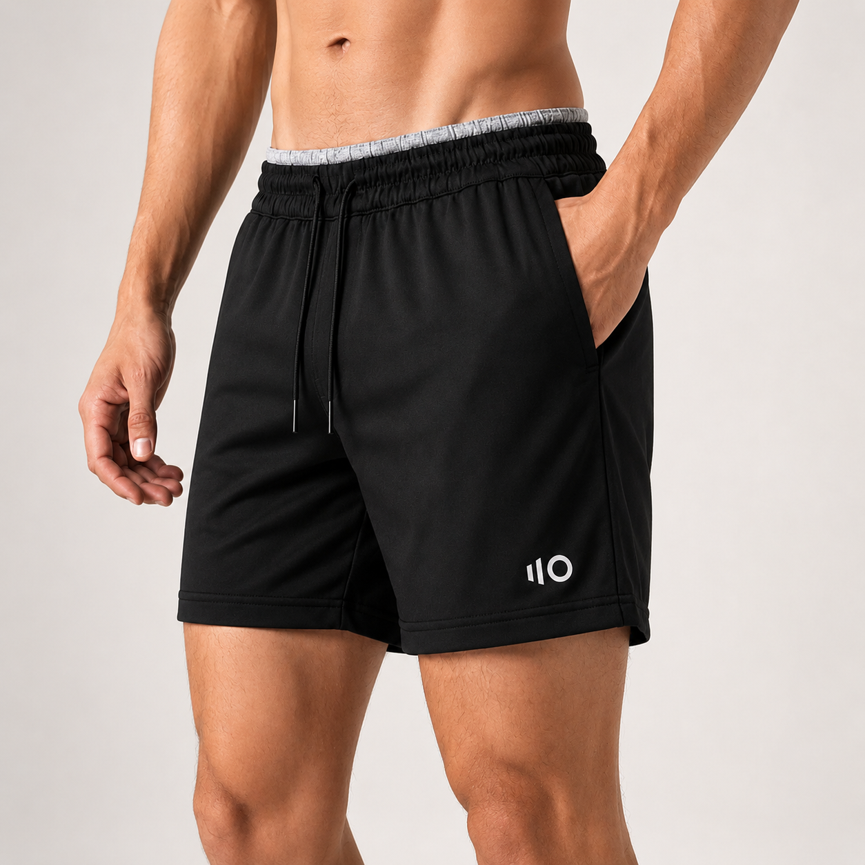Black athletic shorts with a Eleven Zero logo on a gray background