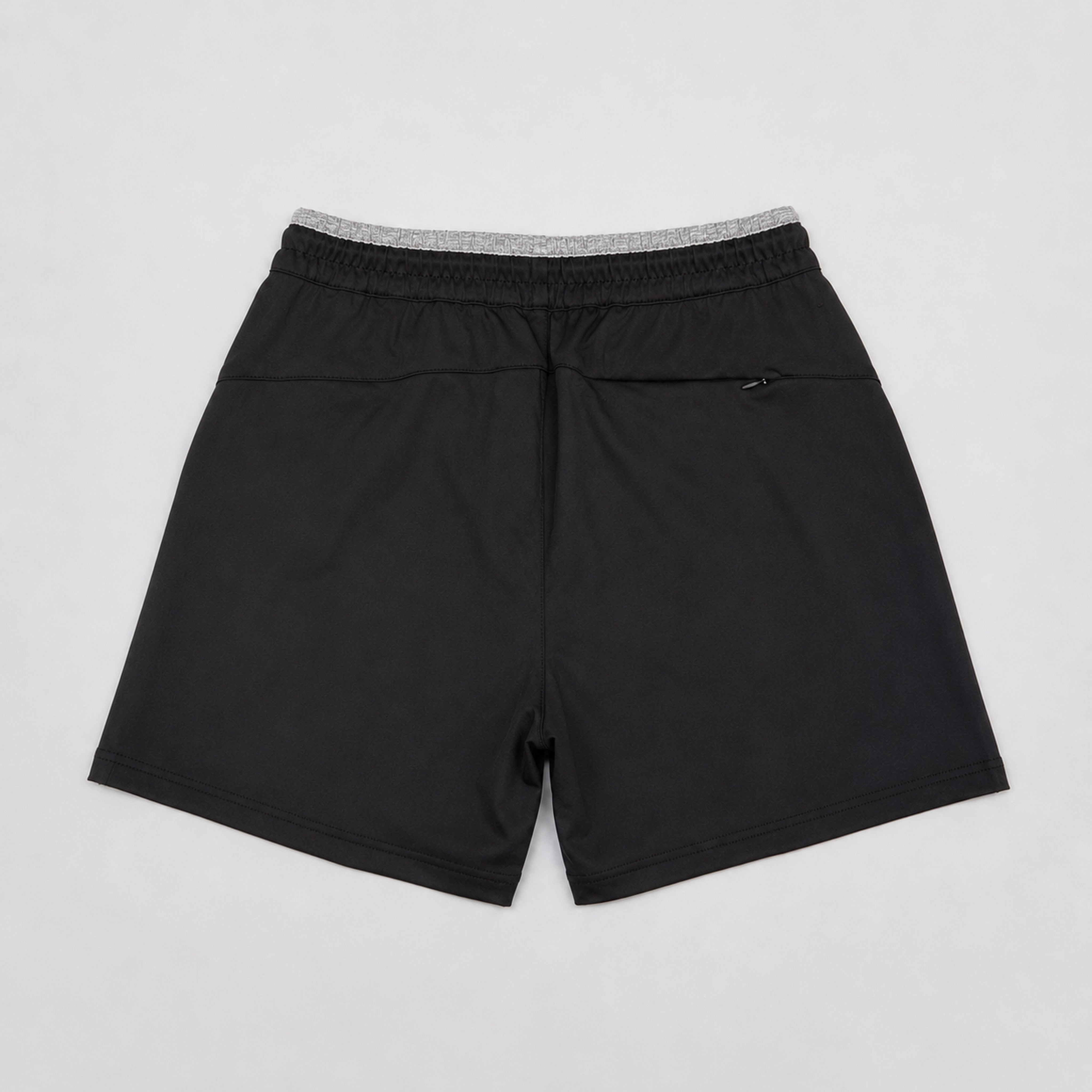 Black shorts with gray waistband on a light gray background