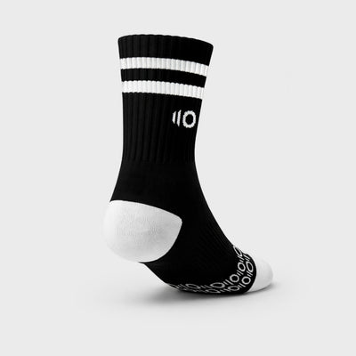 Black sock with white stripes and logo on a light gray background