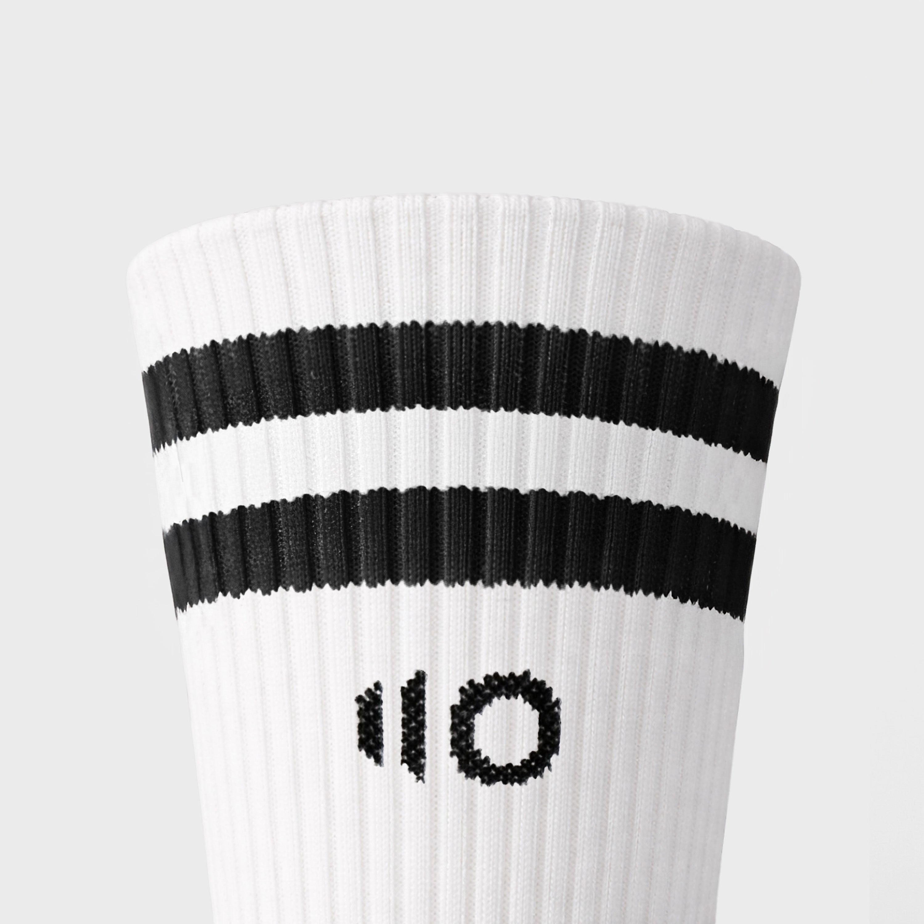 White sock with black stripes and logo on a light gray background