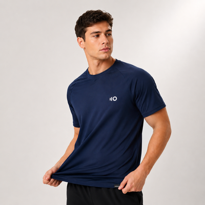 Man wearing a navy blue athletic shirt with Eleven Zero logo on a light gray background