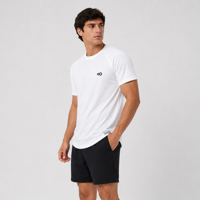 Man wearing a white t-shirt and shorts with a logo on a light gray background
