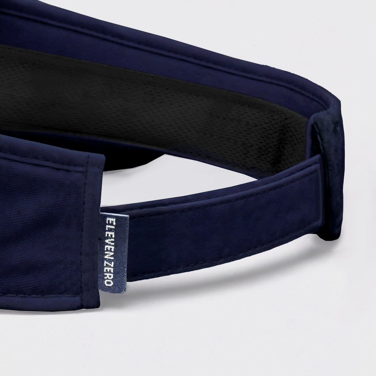 Navy visor with brand logo on a light gray background