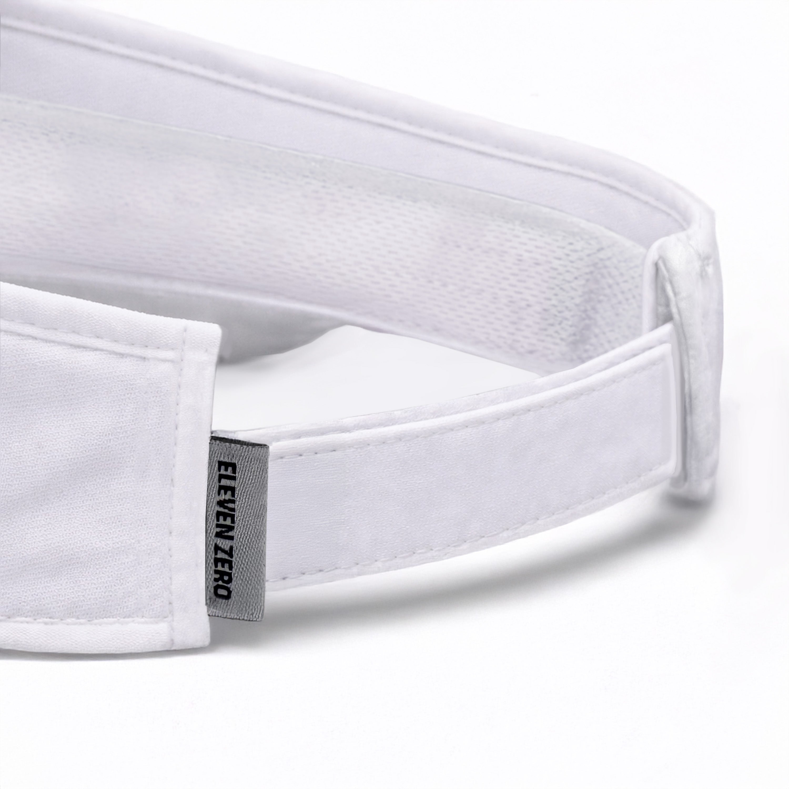 Close-up of a white headband with 'ELEVEN ZERO' label on a light gray background