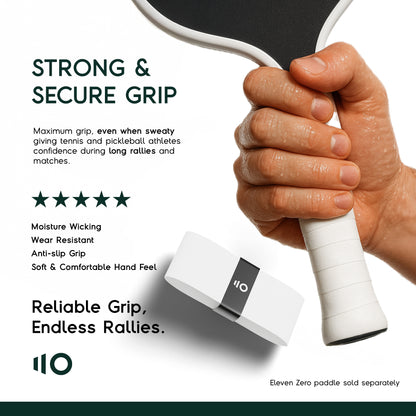 Close-up of a hand gripping an Eleven Zero paddle wrapped with white overgrip, emphasizing strong, moisture-wicking grip performance.