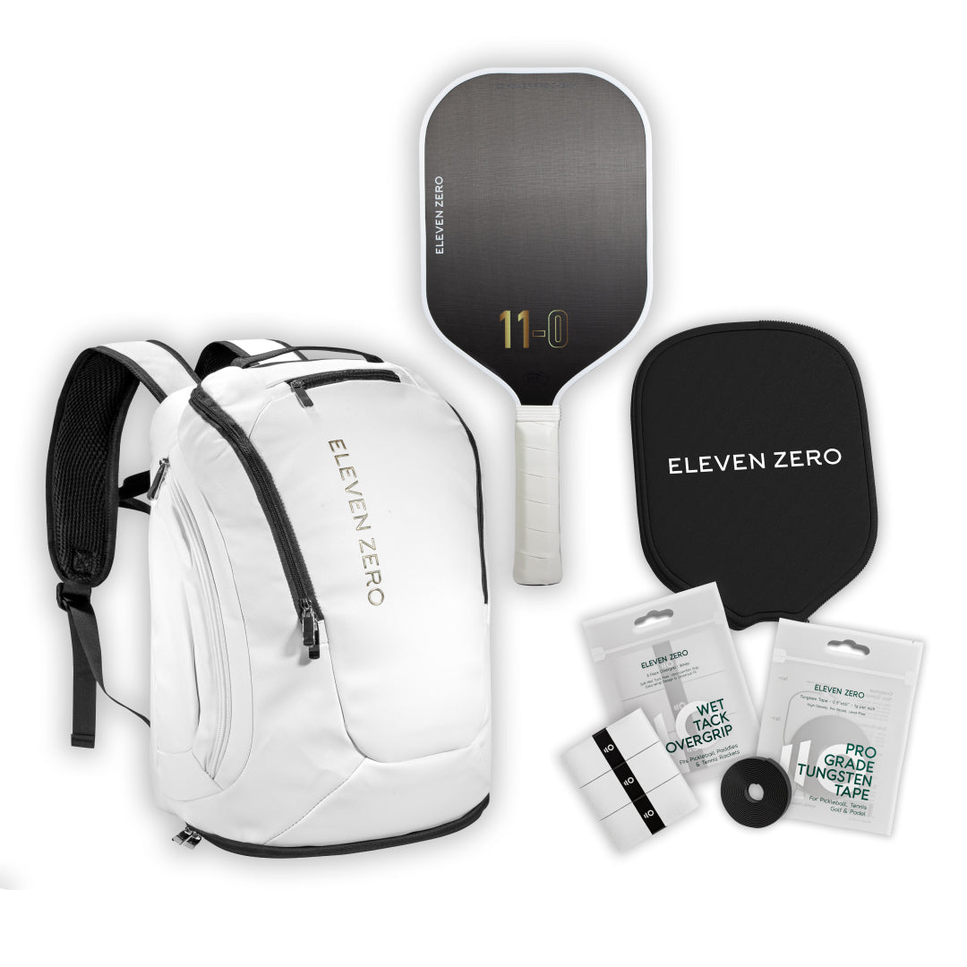 White Eleven Zero pickleball backpack shown with carbon paddle, paddle cover, overgrips, and tungsten tape.